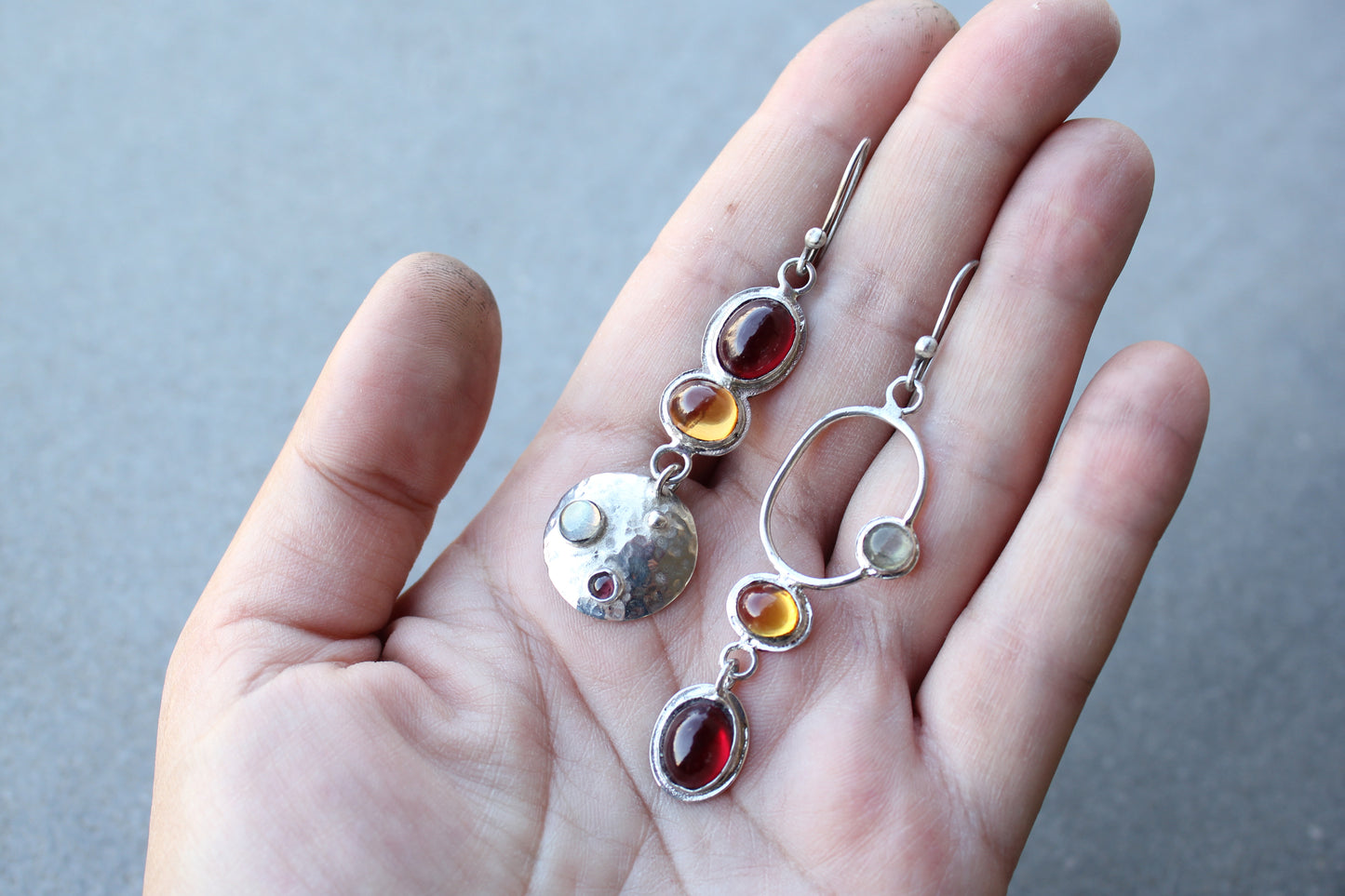 Mismatched sterling silver Armenian artisan handmade drop earrings, featuring oval red and orange corundums and labradorite stones