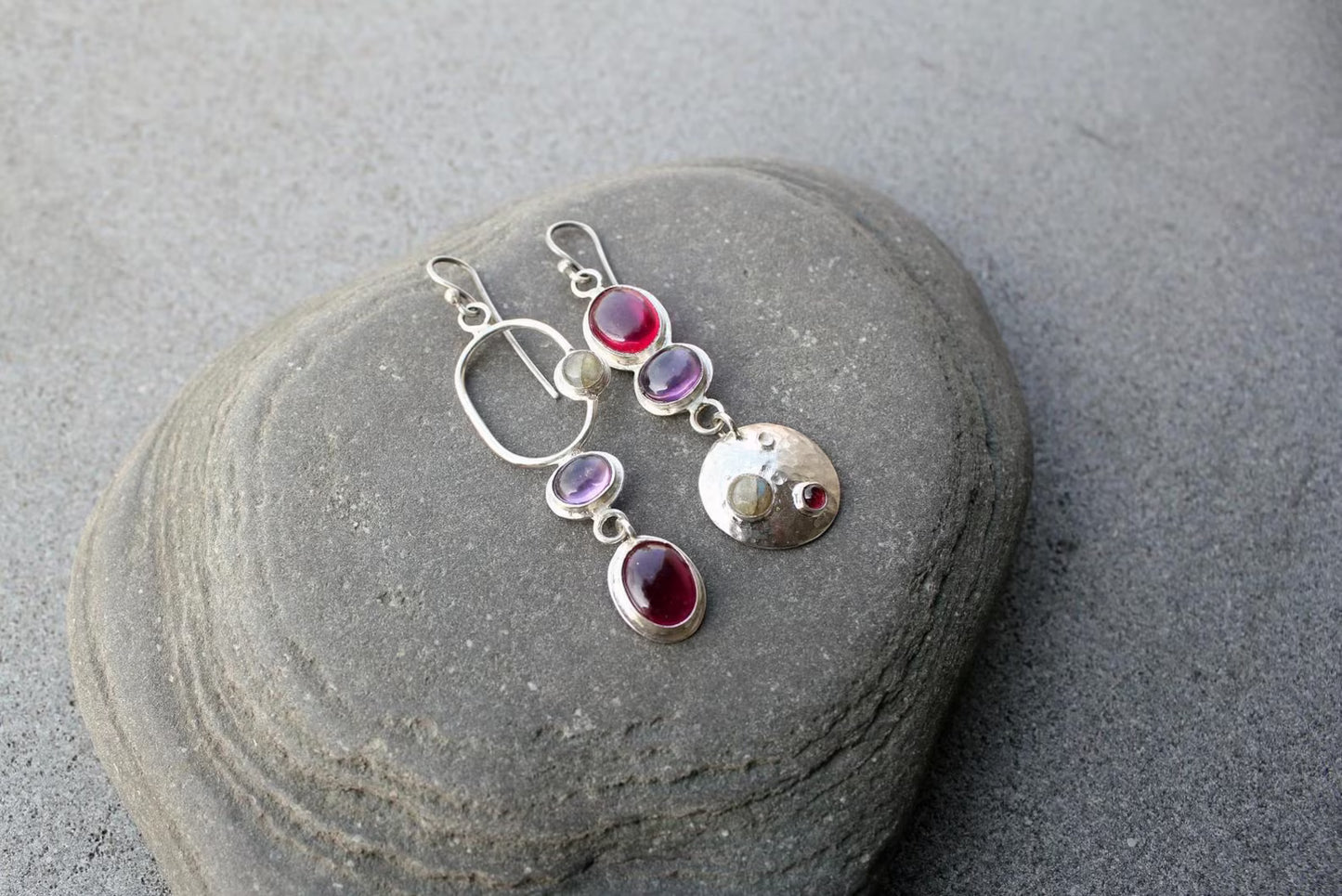 Mismatched sterling silver silversmith Armenian artisan handmade drop earrings, featuring oval red and purple corundums and labradorite stones