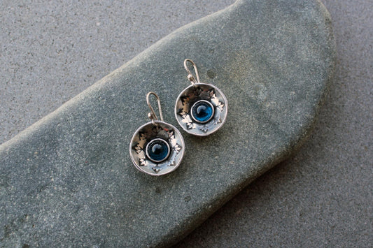 Handcrafted artisan Armenian silversmith sterling silver concave disc earrings featuring a central blue corundum cabochon, accented by stamped geometric patterns