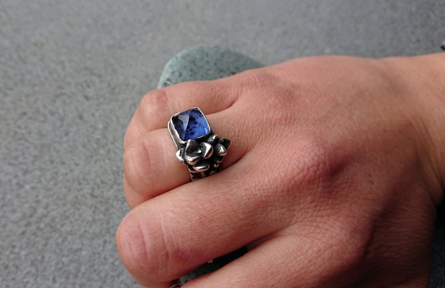 Artisan Armenian handmade sterling silver ring with rectangular lab-grown blue corundum gemstone, accented with organic twig textures and hand cast succulent details