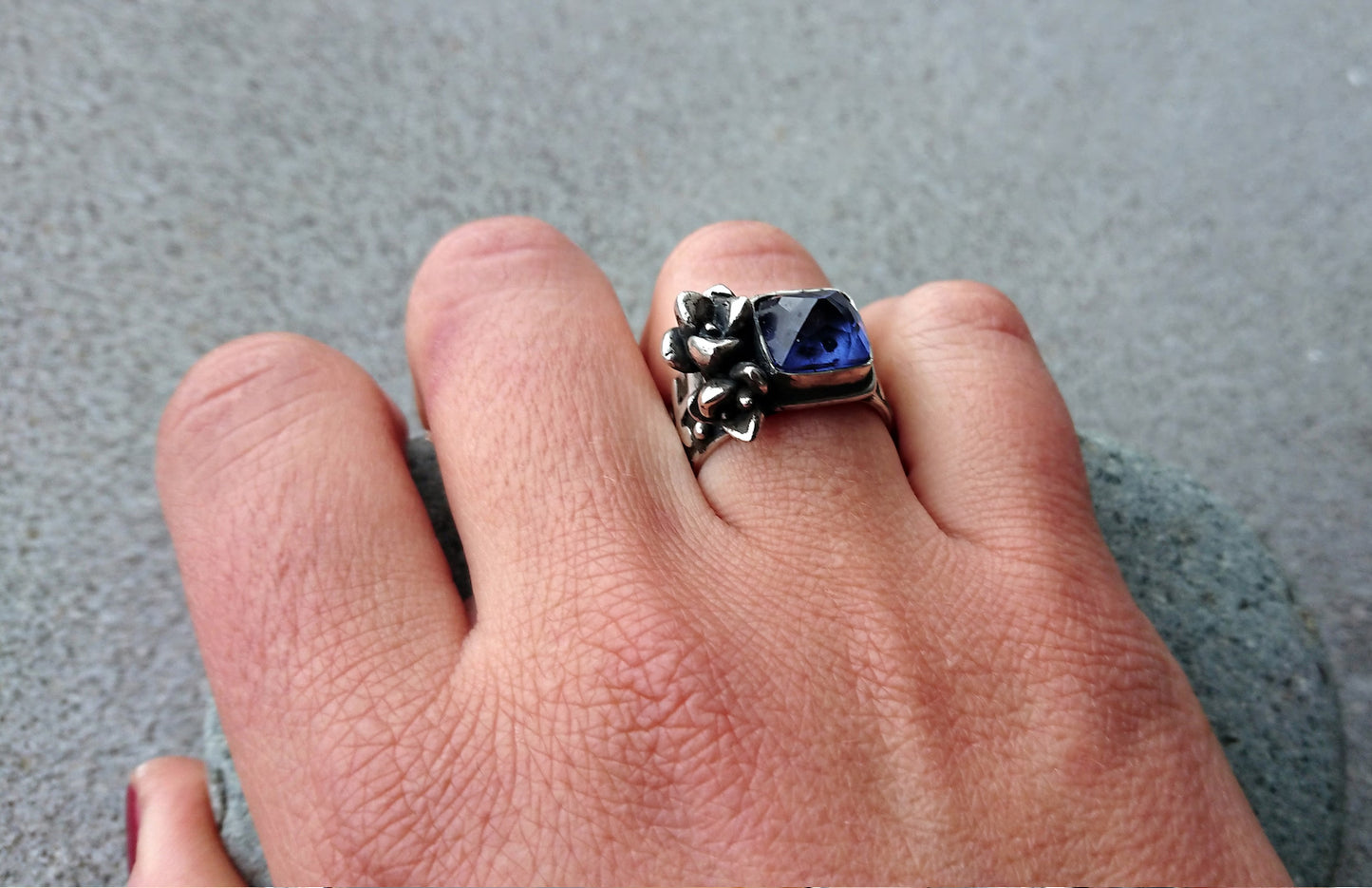 Artisan Armenian handmade sterling silver ring with rectangular lab-grown blue corundum gemstone, accented with organic twig textures and hand cast succulent details