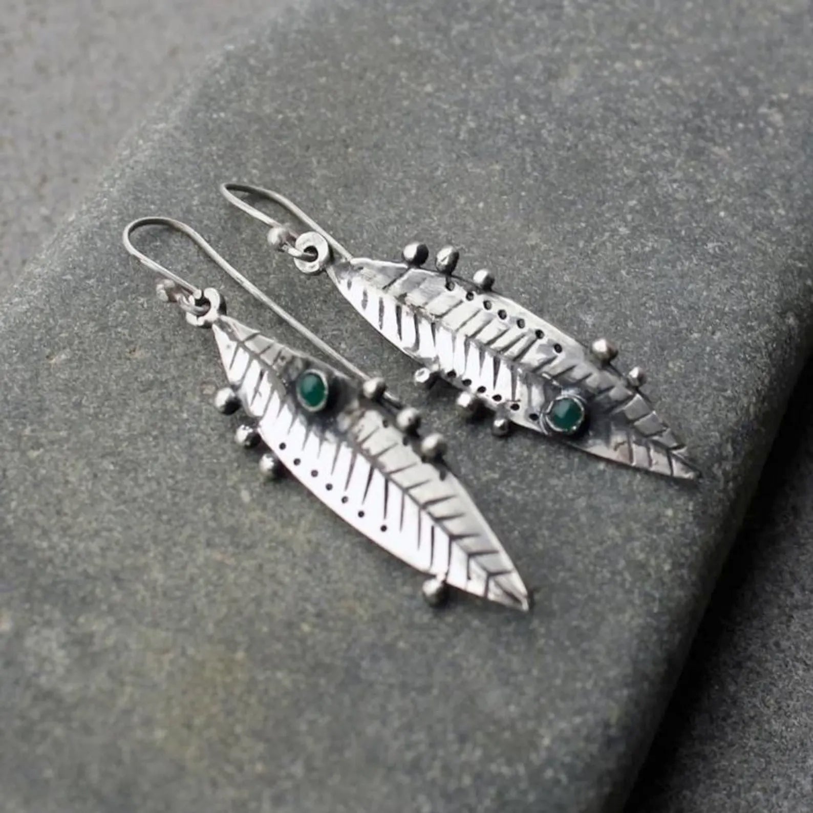 Handmade Armenian sterling silver leaf earrings featuring small round green onyx gemstones, oxidized finish with granule detailing