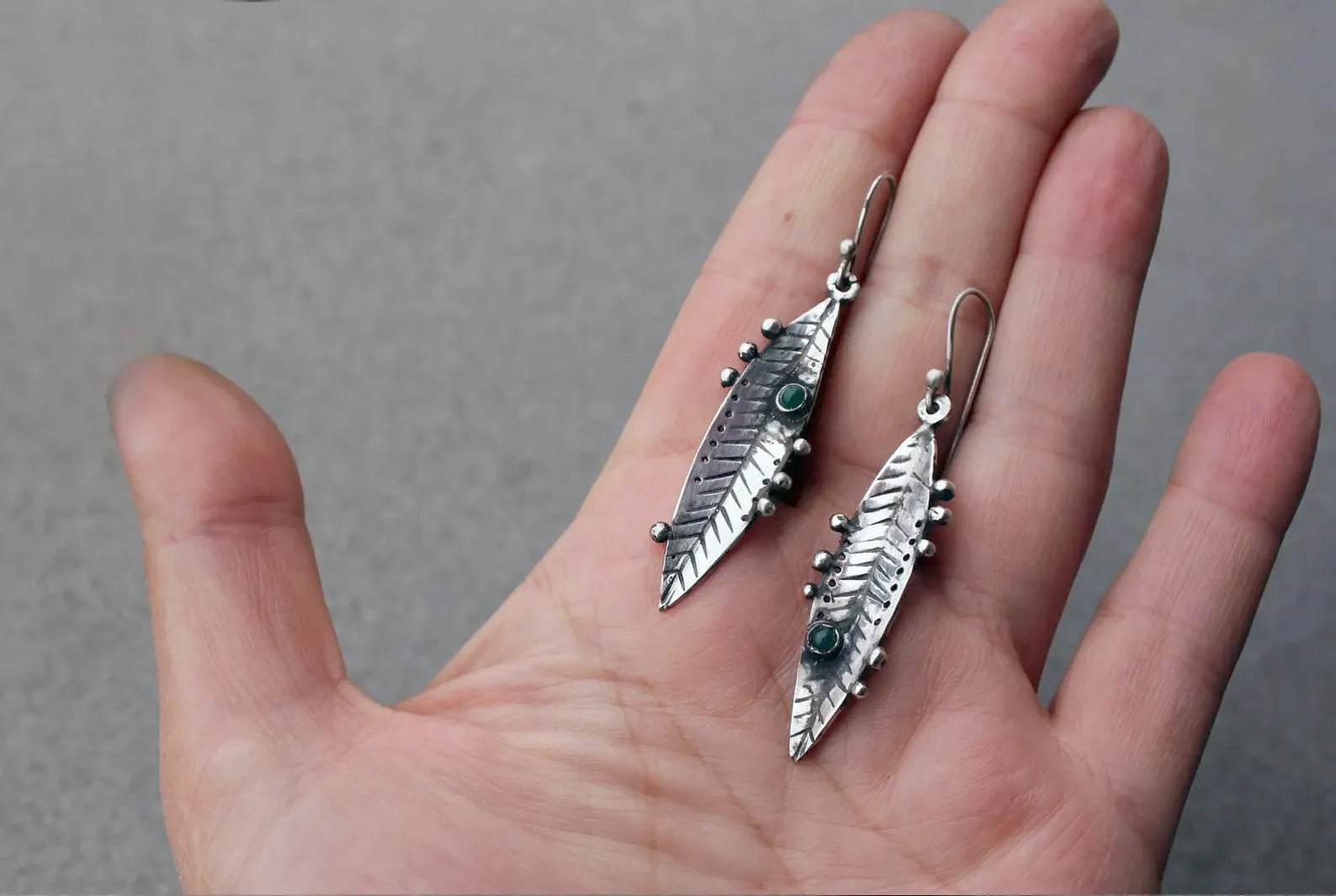 Handmade Armenian sterling silver leaf earrings featuring small round green onyx gemstones, oxidized finish with granule detailing