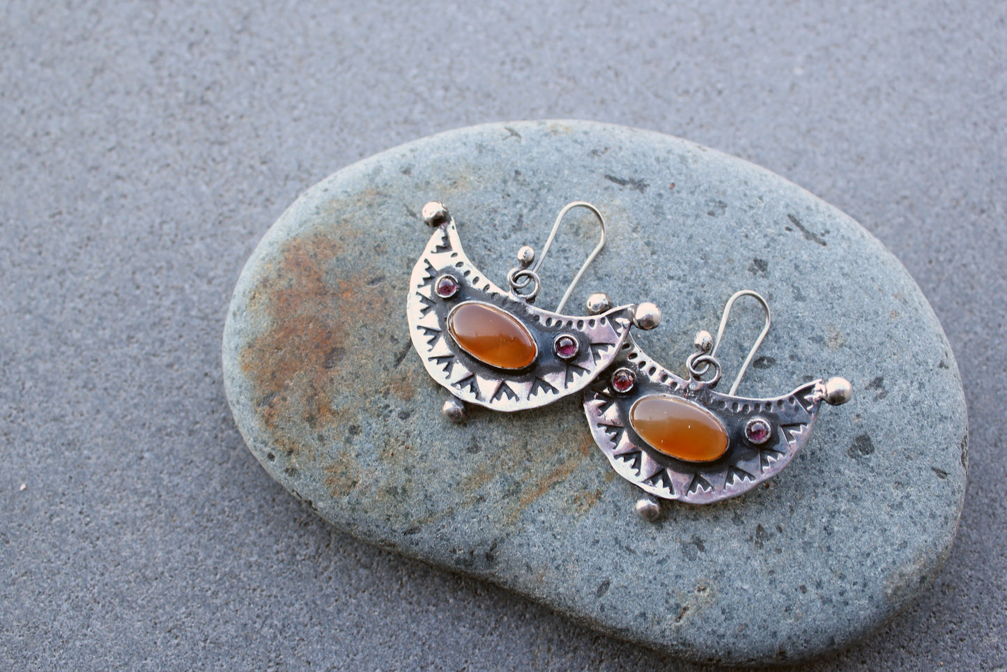 Artisan Armenian handmade silver earrings featuring oval carnelian cabochons and red garnet accents with traditional stamped detailing
