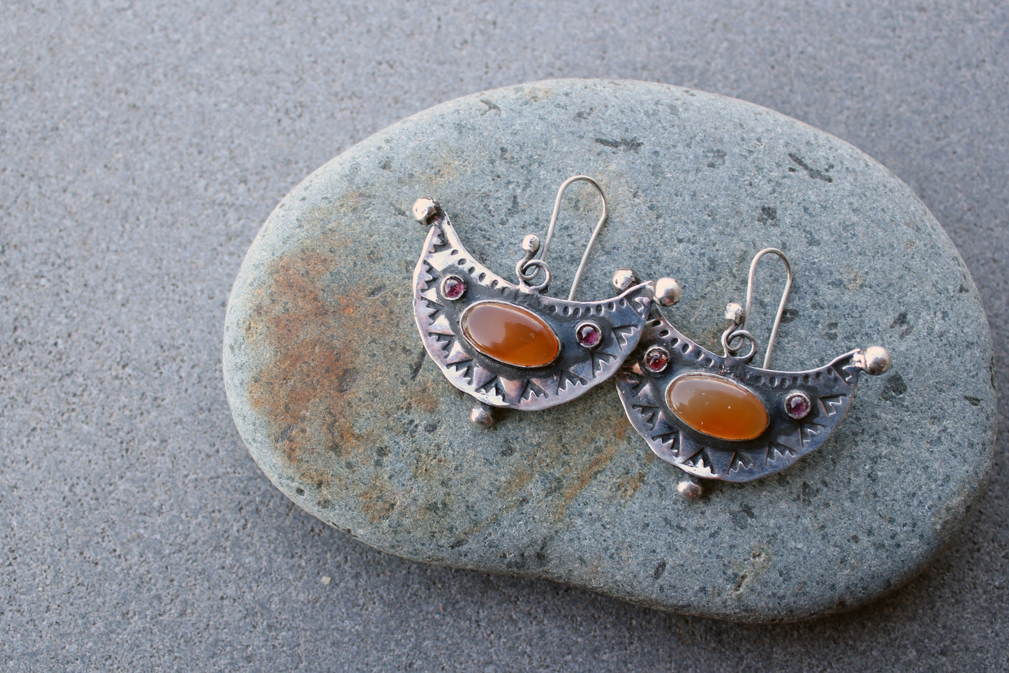 Artisan Armenian handmade silver earrings featuring oval carnelian cabochons and red garnet accents with traditional stamped detailing