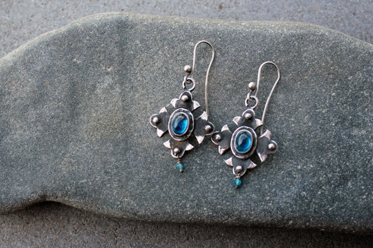 Armenian artisan vintage style sterling silver silversmith earrings featuring oval blue corundum gemstones set in a decorative floral frame