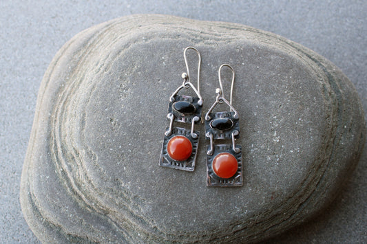 Handcrafted artisan drop earrings featuring oval black onyx and round carnelian  cabochons, set in oxidized sterling silver with tribal-style geometric engravings