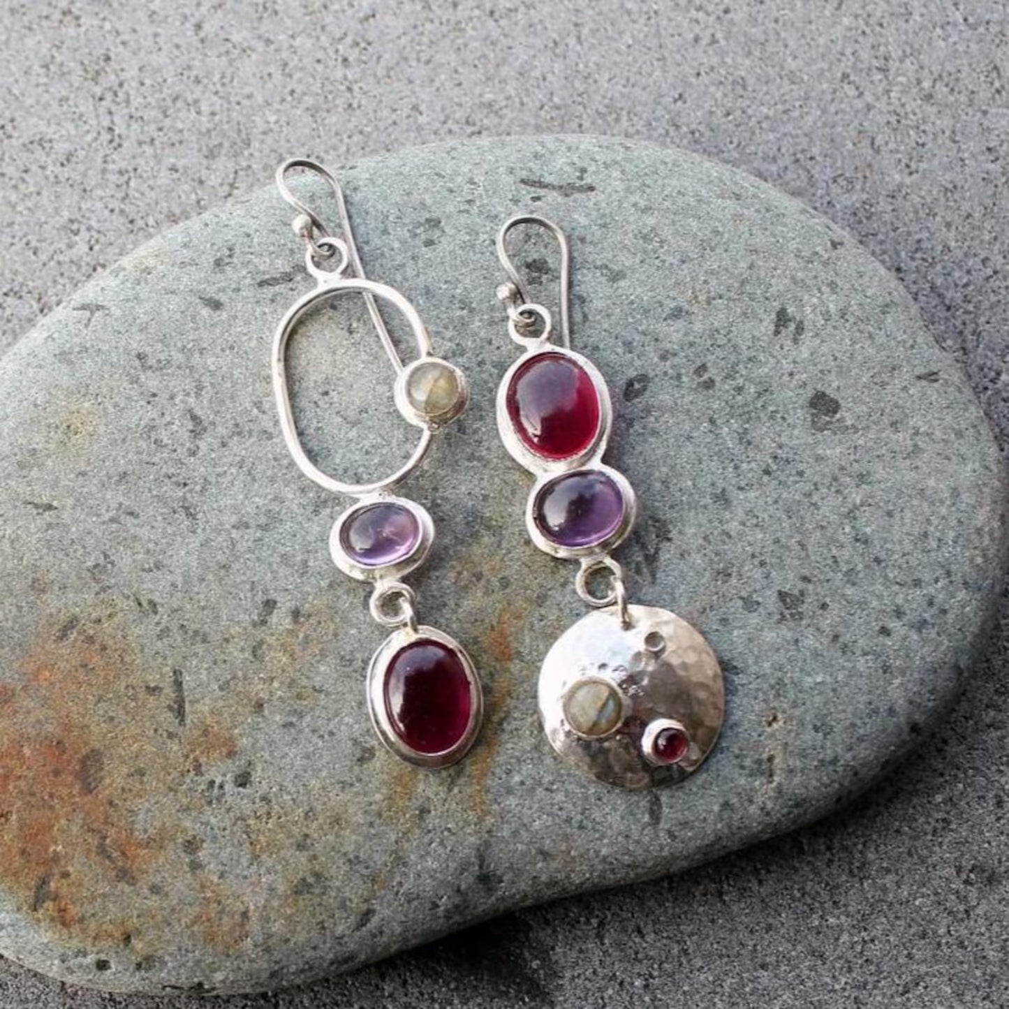Mismatched sterling silver silversmith Armenian artisan handmade drop earrings, featuring oval red and purple corundums and labradorite stones