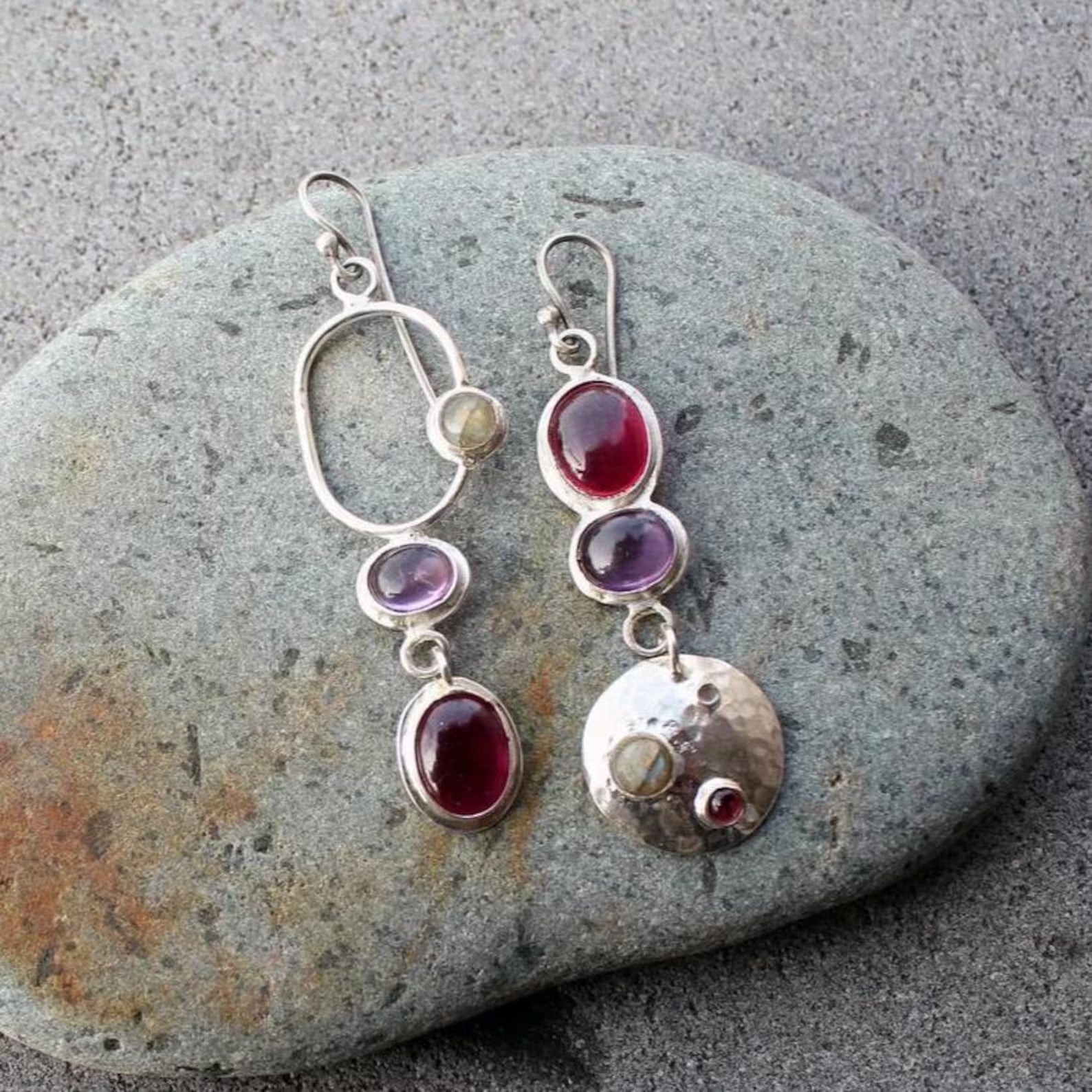 Mismatched sterling silver silversmith Armenian artisan handmade drop earrings, featuring oval red and purple corundums and labradorite stones