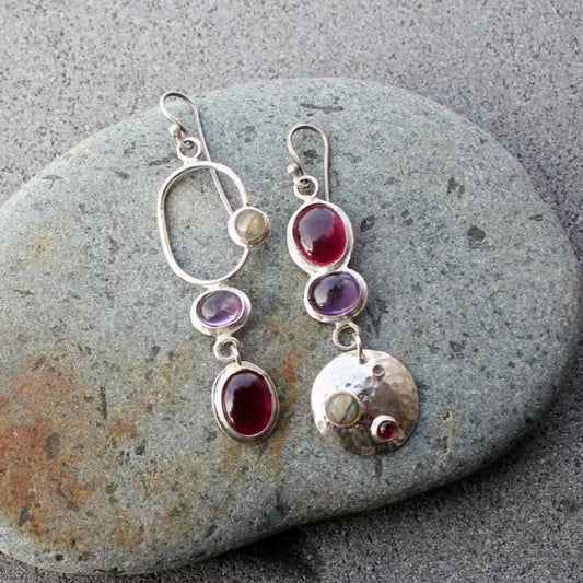Mismatched sterling silver silversmith Armenian artisan handmade drop earrings, featuring oval red and purple corundums and labradorite stones