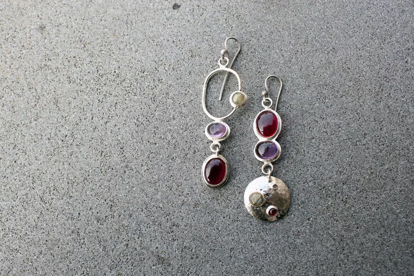 Mismatched sterling silver silversmith Armenian artisan handmade drop earrings, featuring oval red and purple corundums and labradorite stones